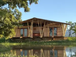 Adobe Bungalow in the evening sun at a small pond in Northern Thailand